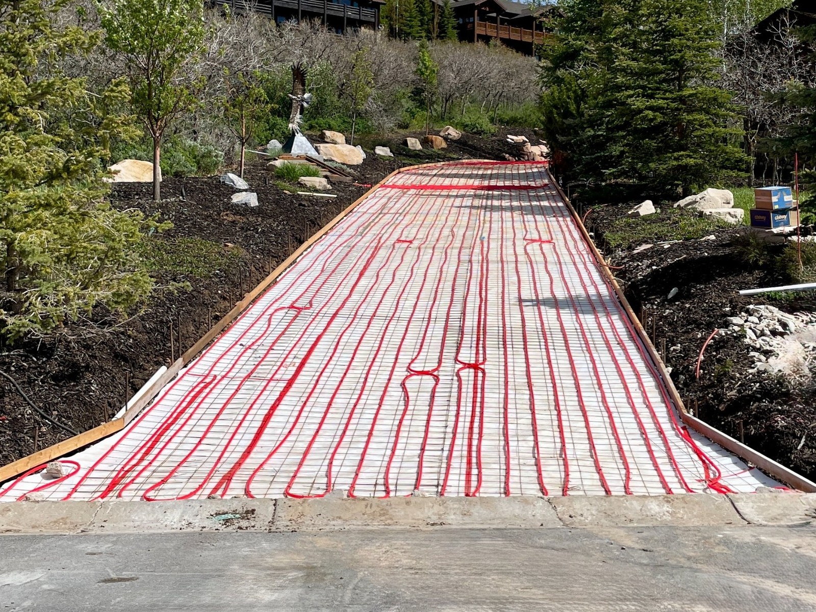 Hydronic snow-melt tubing loops laid out before a concrete driveway pour